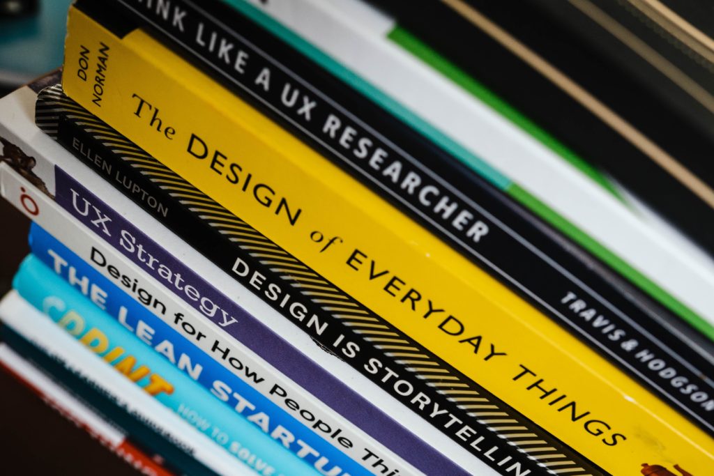 Stack of books on UX design and strategy